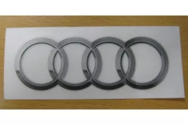 8R0060306A - Exterior: Iconic Four Rings Decal, Silver, Small for Audi: A3, A3 Quattro, A3 Sportback e-tron, A4 allroad, A4 Quattro, A5 Quattro, A5 Sportback, A6 allroad, A6 Quattro, A7 Quattro, A7 Sportback, A8 Quattro, allroad, e-tron GT, Q3, Q4 e-tron, Q5, Q5 Sportback, Q7, Q8, R8, RS e-tron GT, RS3, RS5, RS5 Sportback, RS7, S3, S4, S5, S5 Sportback, S6, S7, S8, SQ5, SQ5 Sportback, SQ7, SQ8, TT Quattro, TT RS Quattro, TTS Quattro Image