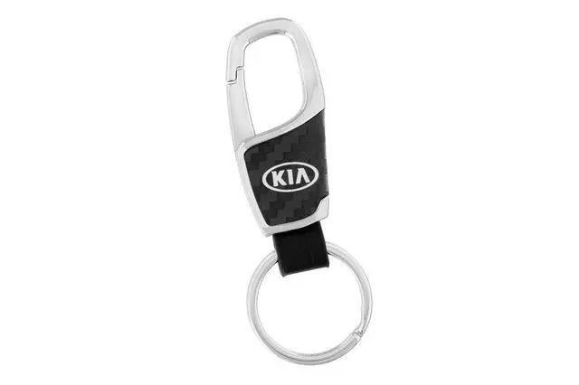 UM016AY740 - Merchandise: Key Chain - Black Carbon Fiber Kia W/Clip for Kia: Cadenza, Carnival, Forte, Forte5, K5, Niro, Niro EV, Optima, Rio, Sedona, Seltos, Sorento, Soul, Soul EV, Sportage, Stinger, Telluride Image