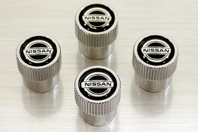 999MBSX000 - Wheels: Valve Stem Caps, Nissan Logo for Nissan: 200SX, 240SX, 300ZX, 350Z, 370Z, Altima, Armada, Axxess, Cube, Frontier, GT-R, Juke, Kicks, LEAF, Maxima, Murano, NV1500, NV200, NV2500, NV3500, NX, Pathfinder, Pickup, Pulsar NX, Quest, Rogue, Rogue Sport, Sentra, Stanza, TITAN, TITAN XD, Versa, Versa Note, Xterra Image