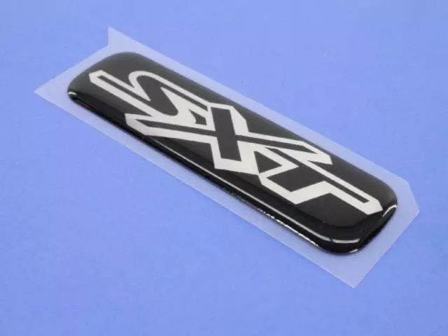 4806063AA - Exterior Ornamentation: Sxt Nameplate for Mopar Image