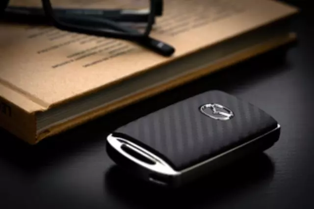 C9N1V0450 - Security: Key Fob Cover - Carbon Fiber for Mazda: 3, CX-30, CX-5, CX-50, CX-70, CX-9, CX-90, MX-30 EV Image