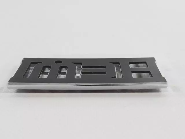 55077830AA - Exterior Ornamentation: Nameplate for Mopar Image